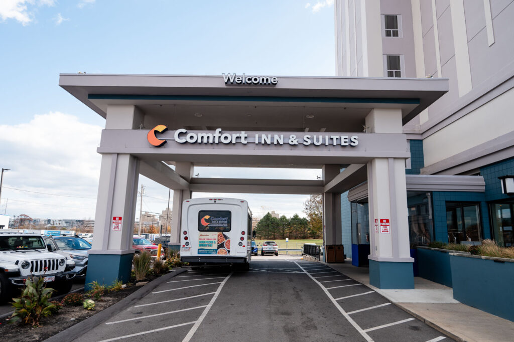Comfort Inn & Suites Logan International Airport entrance with shuttle bus under porte-cochere